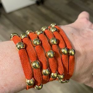 Beautiful orange suede cuffs with studs. NWOT. Never worn